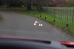 view through an Audi vehicle windscreen with a heads up display of speed, speed limit, and the lane keep assist iconprojected onto it